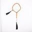 Sandalwood prayer strand for sale with 33 beads, black tassels, and a carved wooden centerpiece