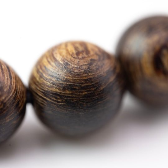 Authentic agarwood bracelet online in a macro view showing striped 8mm bead grain