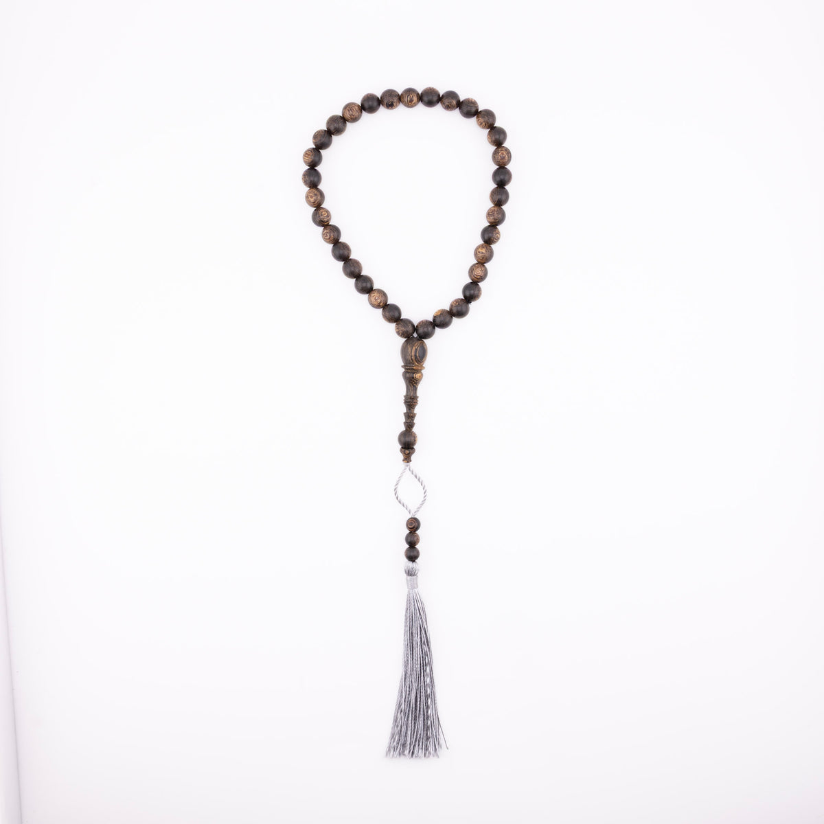Buy agarwood prayer beads with a grey tassel displayed on a white background