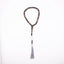 Buy agarwood prayer beads with a grey tassel displayed on a white background