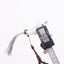 Buy agarwood prayer beads with one bead measured beside the grey tassel