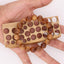 Buy natural sandalwood bracelet held over a wooden bead-sizing board