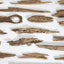 Natural agarwood chips and resinous wood slivers arranged on a white surface